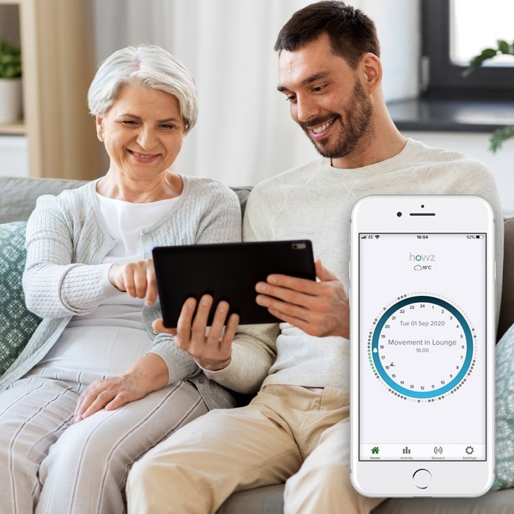 A mother and son using Howz remote care monitoring technology at home
