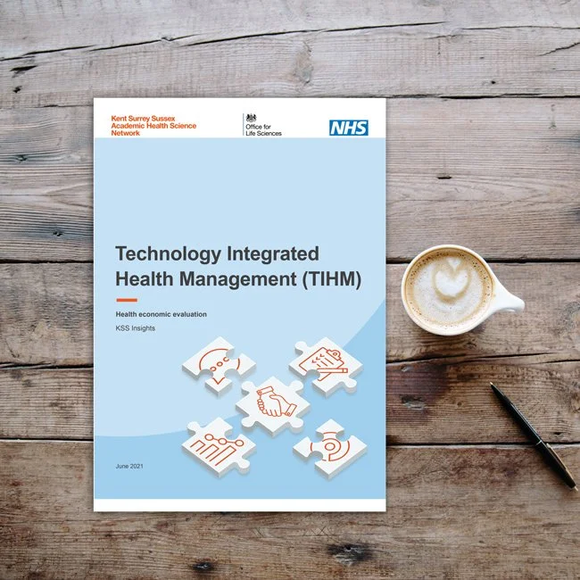 The NHS report on a wooden table with a pen and coffee